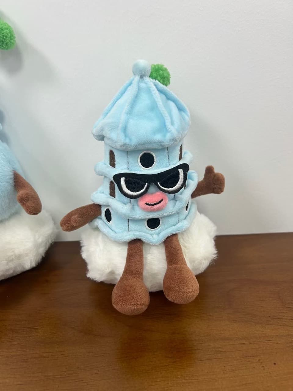 Lighthouse plush toy wearing sunglasses