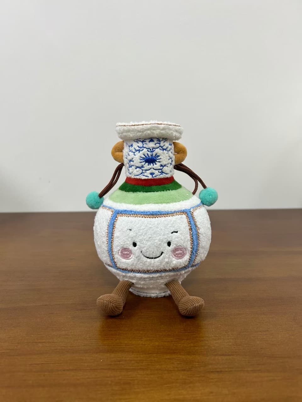 Novelty porcelain vase shaped plush toy with a face