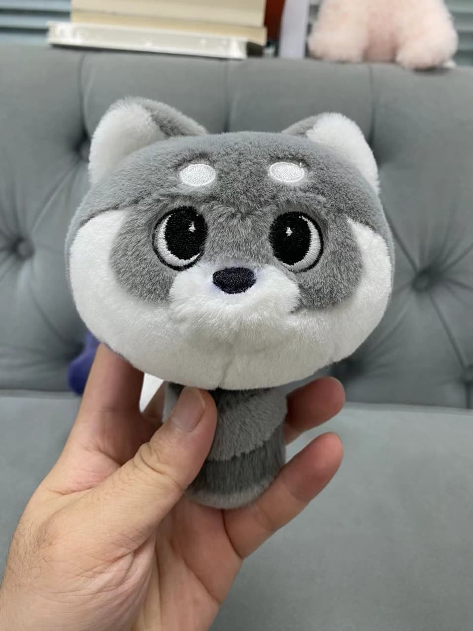 Grey raccoon plush toy with big eyes