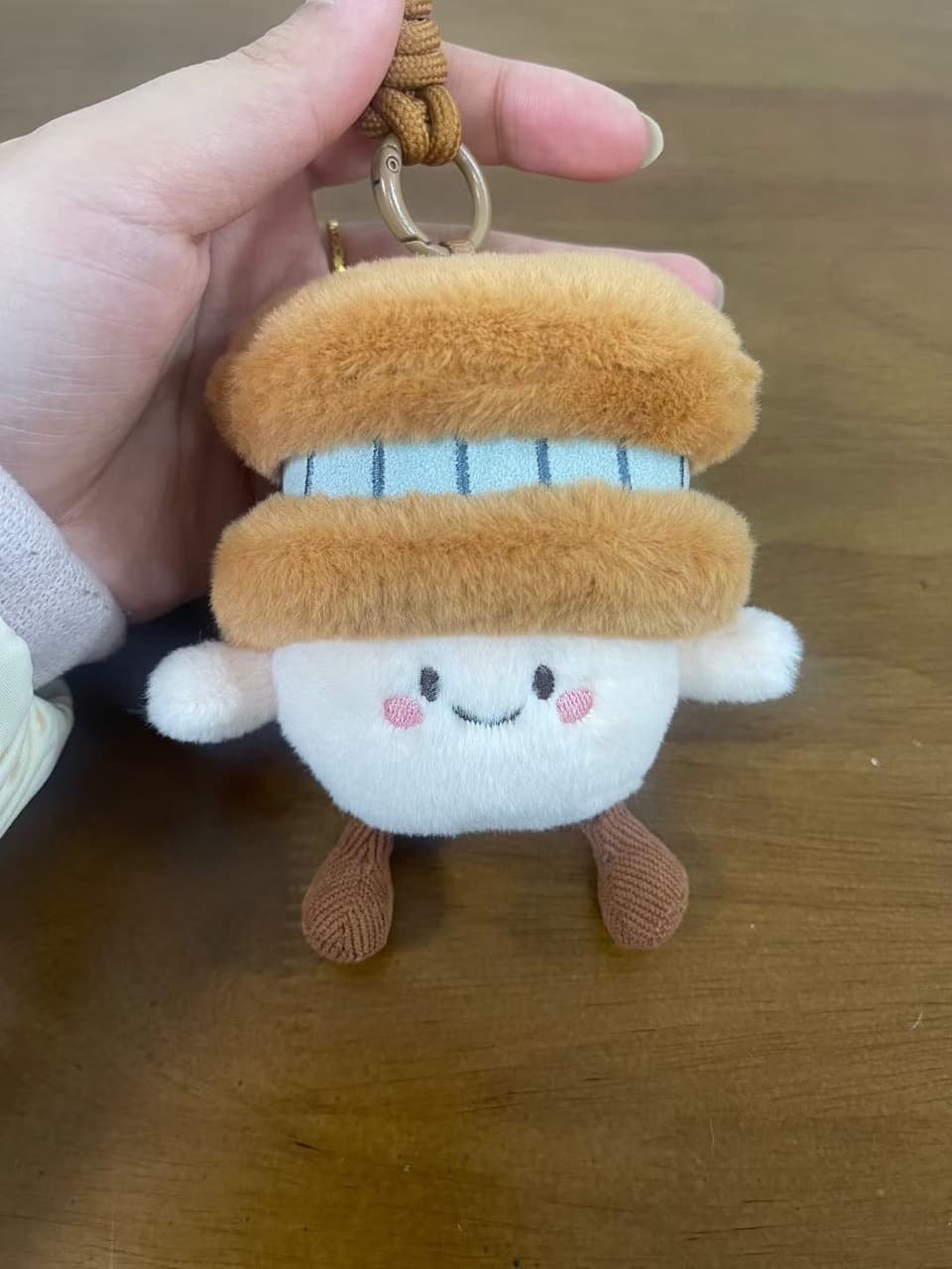 Sandwich-shaped plush keychain charm with a smiling face